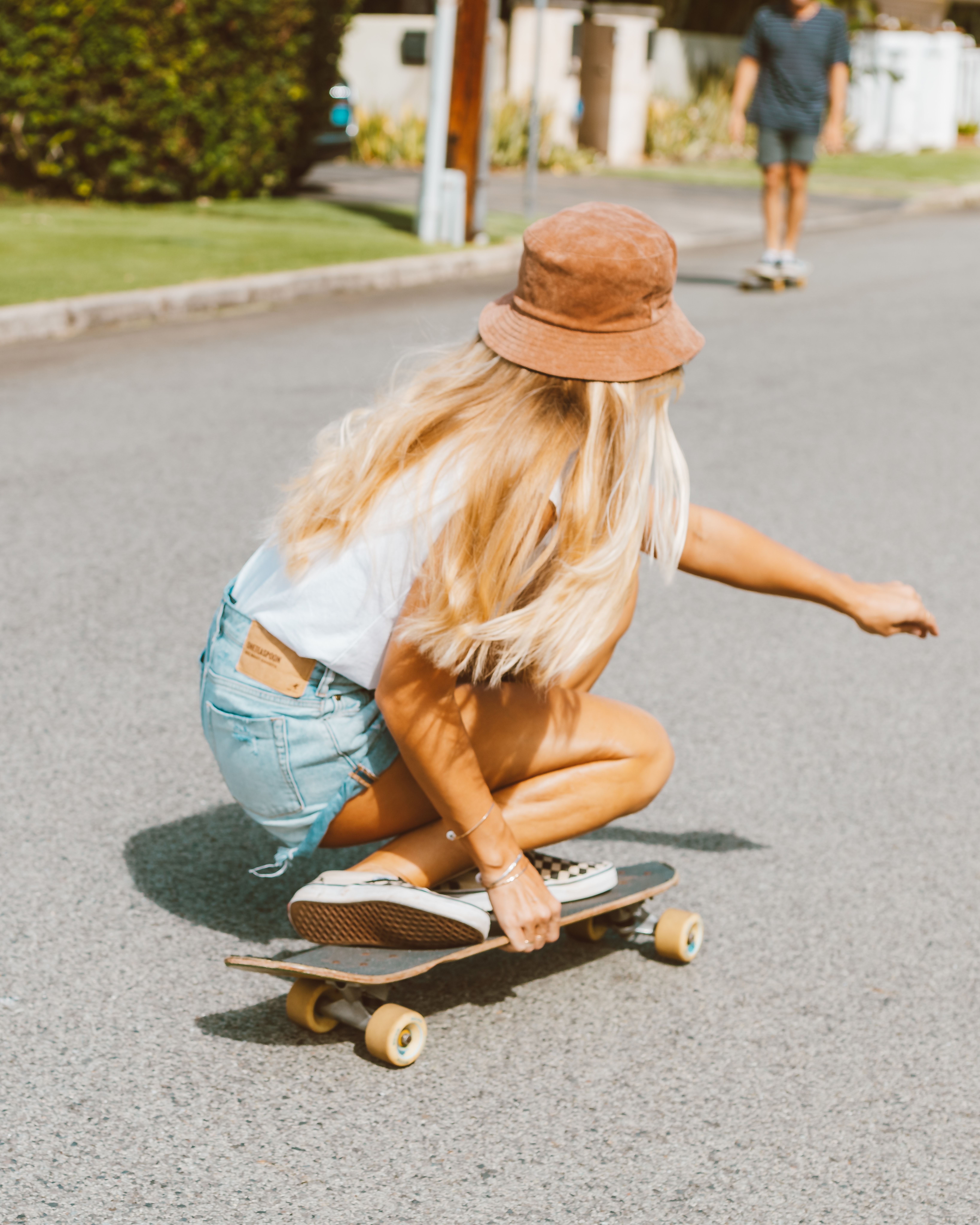 woman crouching on skateboard