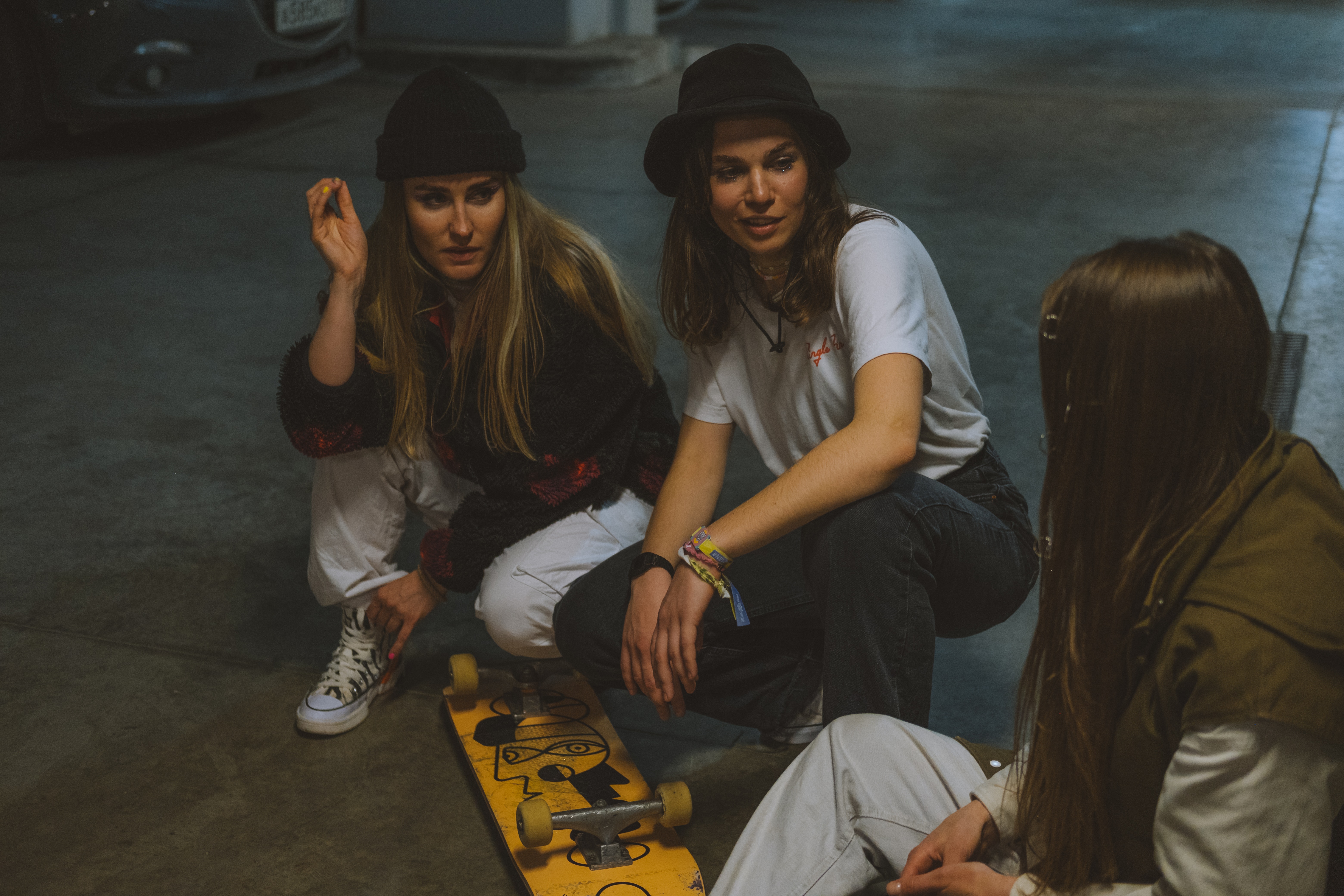Three women together with skateboards