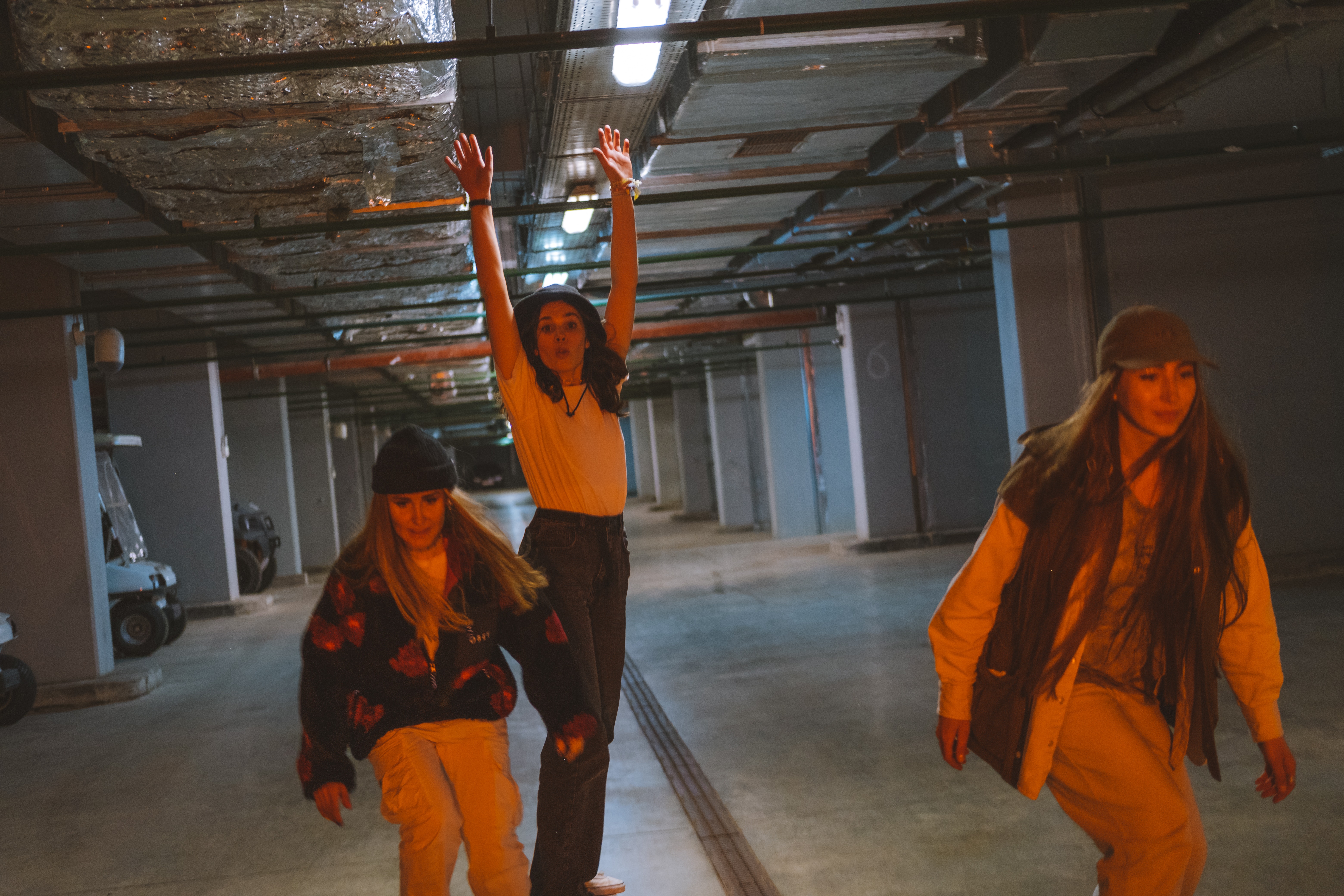 Three skaters in underground carpark