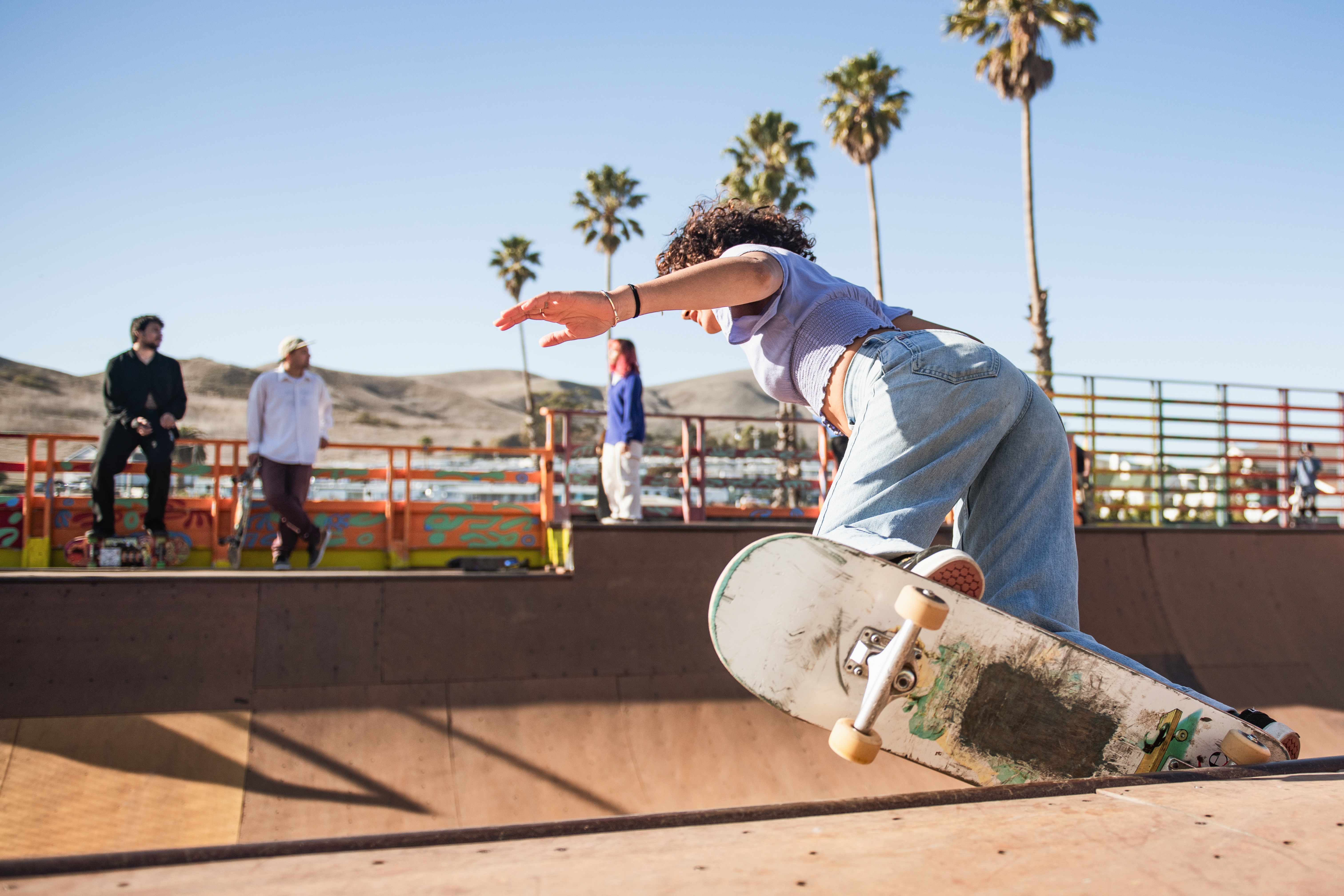 woman doing trick on outdoor ramp